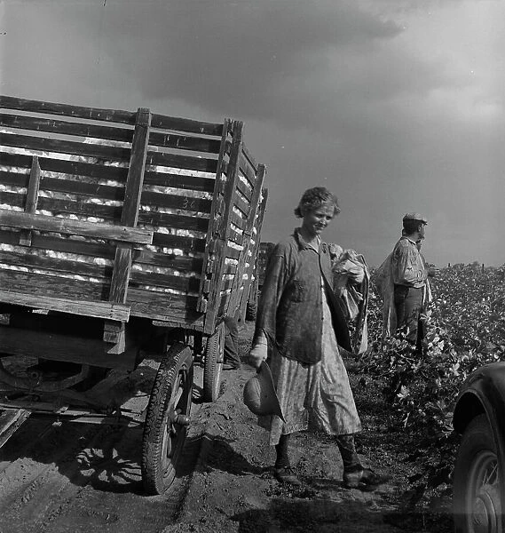 Migratory cotton pickers have stopped working because it started to rain, Kern County, CA, 1938. Creator: Dorothea Lange
