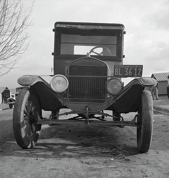 Model T Fords still carry migrants, FSA migratory labor camp at Farmersville, California, 1939. Creator: Dorothea Lange