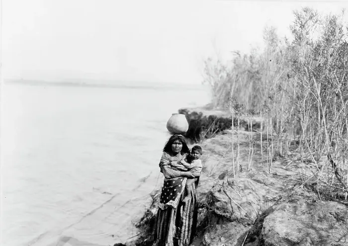 Framed Print : Mohave woman carrying water on her head and holding child, c1903. Creator: Edward Sheriff Curtis Framed Print : Mohave woman carrying water on her head and holding child, c1903. Creator: Edward Sheriff Curtis