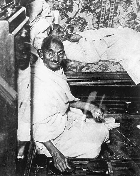 Mohondas Karamchand Gandhi (1869-1948), working at his spinning wheel