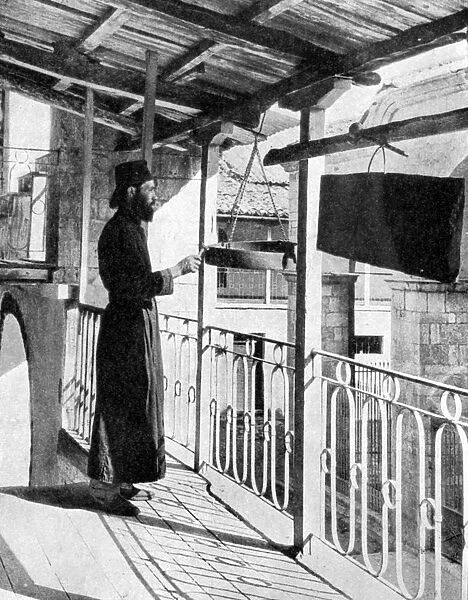 Monk sounding the call to prayer on a gong, Greece, 1936. Artist: Nomias