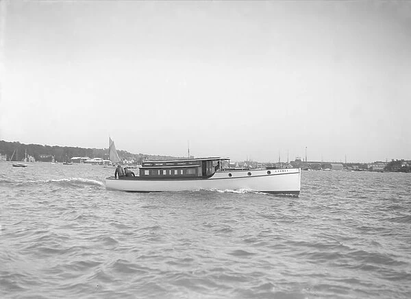 The motor launch Cygnet under way, 1912. Creator: Kirk & Sons of Cowes