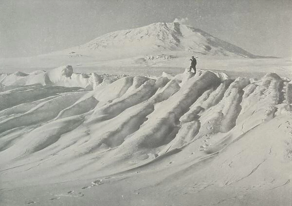 Mount Erebus Over a Water-Worn Iceberg, October 1911, (1913). Artist: Herbert Ponting