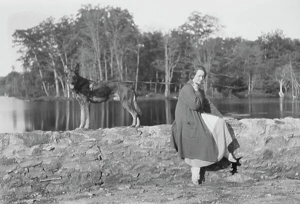 Mower, Margaret, Miss, with dog, seated outdoors, not before 1916. Creator: Arnold Genthe