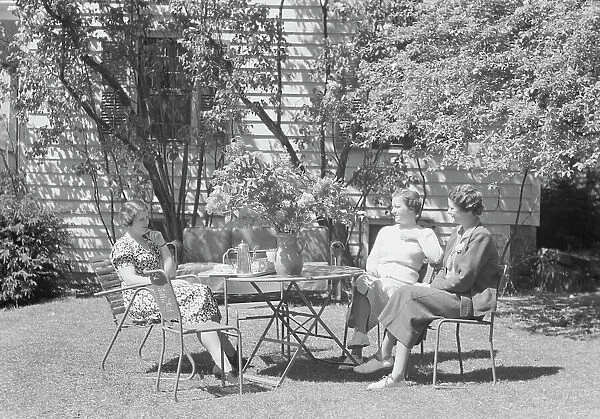 Mrs. Mary Benson and two identified women seated outdoors at a table, between 1933 and 1942. Creator: Arnold Genthe