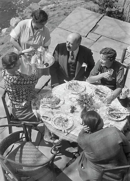 Mrs. Mary Benson and other people seated outdoors, 1933. Creator: Arnold Genthe