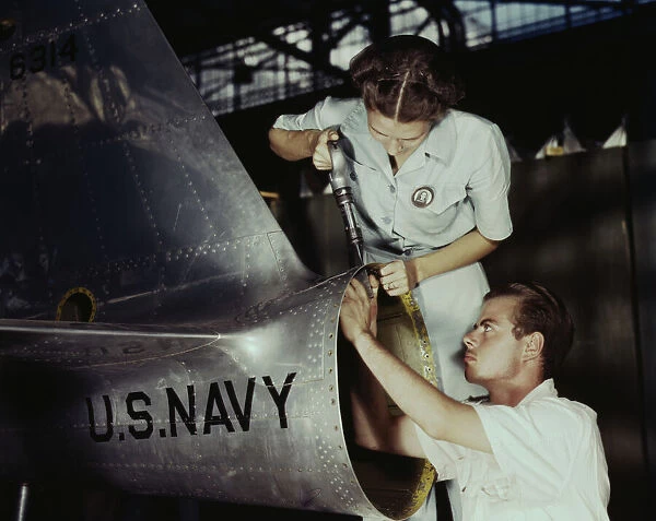Mrs. Virginia Davis, a riveter in the assembly and repair department of the Naval air base... 1942. Creator: Howard Hollem