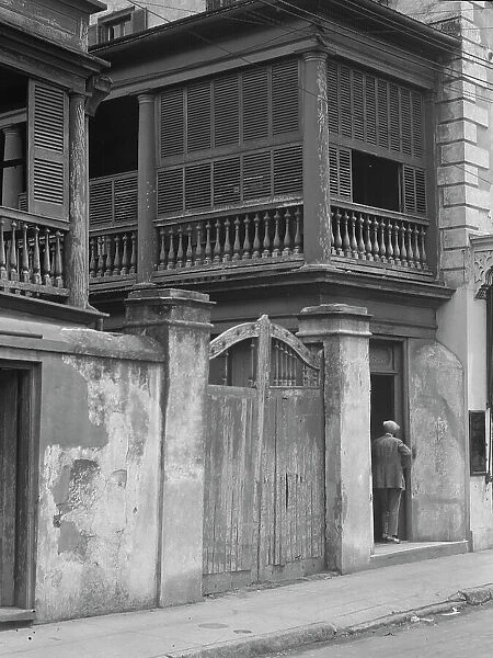 Multi-story house behind gated wall, New Orleans or Charleston, South Carolina, c1920-1926. Creator: Arnold Genthe
