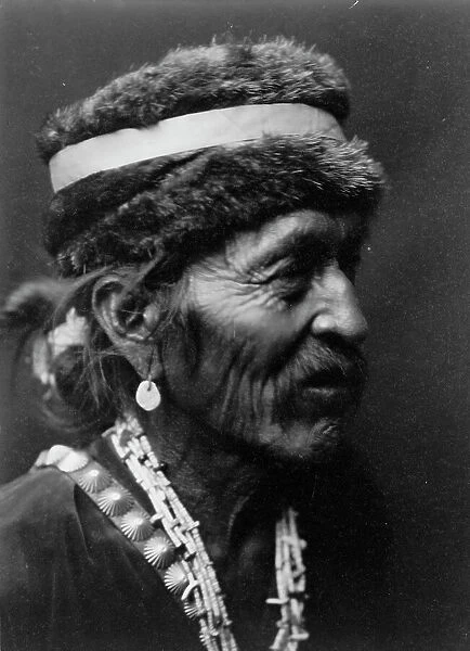 Navajo with fur cap, c1905. Creator: Edward Sheriff Curtis