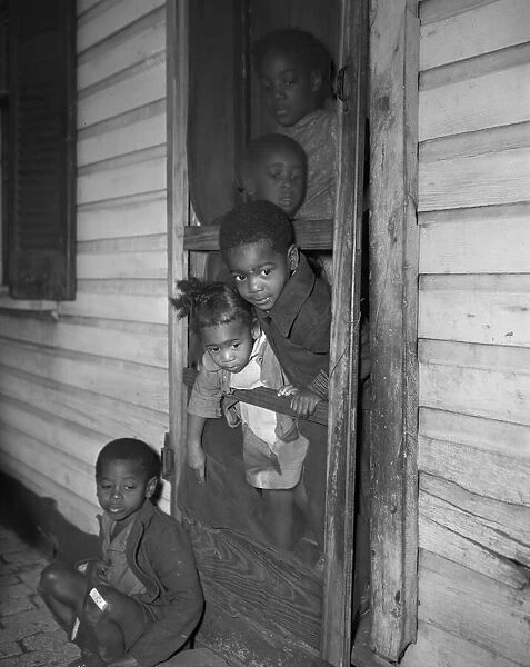 Negro children in the front door of their home, Washington (southwest section), D. C. 1942. Creator: Gordon Parks