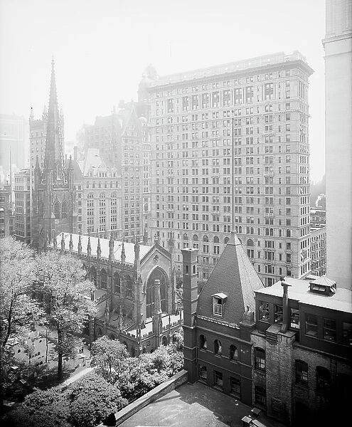 New York, N.Y. Trinity churchyard and the skyscrapers, between 1900 and 1920. Creator: Unknown