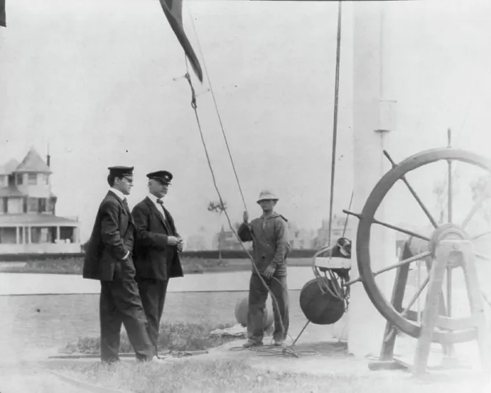 Framed Print : New York Yacht Club, Oyster Bay, L.I. 1905: 2 men watching sailor hoist flag, 1905. Creator: Frances Benjamin Johnston Framed Print : New York Yacht Club, Oyster Bay, L.I. 1905: 2 men watching sailor hoist flag, 1905. Creator: Frances Benjamin Johnston