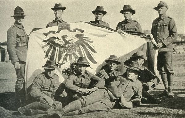 New Zealand soldiers with captured German flag, First World War, 1914, (c1920). Creator: Unknown