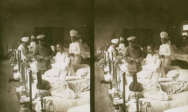 Nurses and a doctor attending wounded soldiers on a hospital ward, c1905. Creator: Underwood & Underwood. Nurses and a doctor attending wounded soldiers on a hospital ward, c1905. Creator: Underwood & Underwood