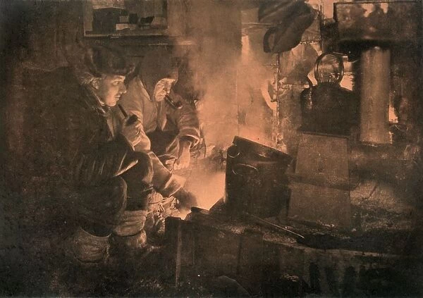 Oates and Meares at the Blubber-Stove in the Stables, 1911, (1913). Artist: Herbert Ponting