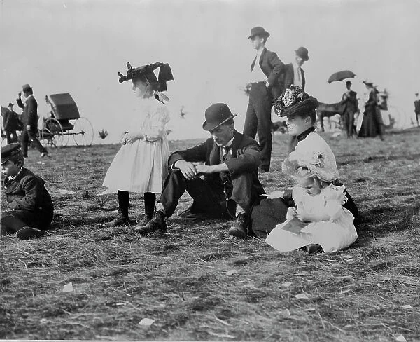 Parents and children seated on grass at state fair, St. Paul, Minnesota, 1900?. Creator: Unknown