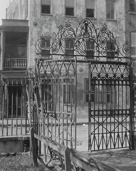 Park gate and houses, [36 Chalmers Street through Washington Park Gate], Charleston... c1920-c1926. Creator: Arnold Genthe