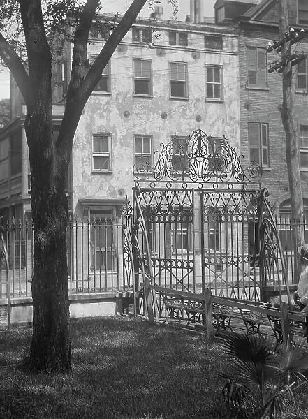 Park and houses, [36 Chalmers Street through Washington Park Gate], Charleston... c1920-c1926. Creator: Arnold Genthe