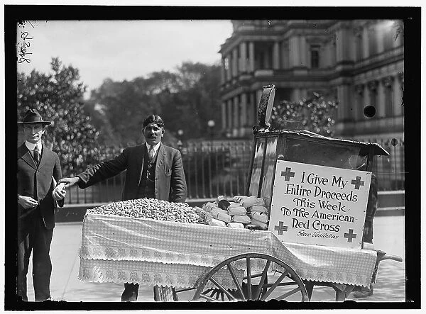 Peanut vendor Steve Vasilakas standing near his cart... between 1916 and 1918. Creator: Harris & Ewing. Peanut vendor Steve Vasilakas standing near his cart... between 1916 and 1918. Creator: Harris & Ewing