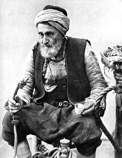 A peasant drinking coffee and smoking a huqqah, Izmir, Turkey, 1936