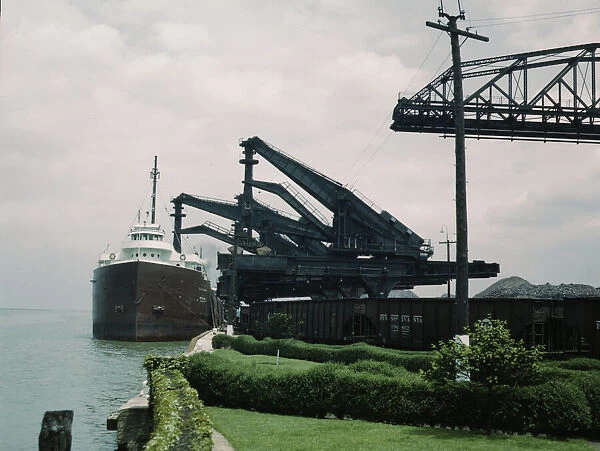 Pennsylvania R.R. [Railroad] ore docks, unloading iron ore from a lake... Cleveland, Ohio, 1943. Creator: Jack Delano