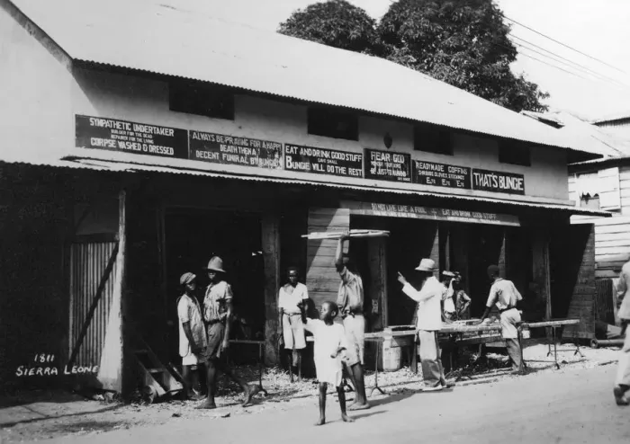 Framed Print : People outside an undertakers premises, Sierra Leone, 20th century Framed Print : People outside an undertakers premises, Sierra Leone, 20th century