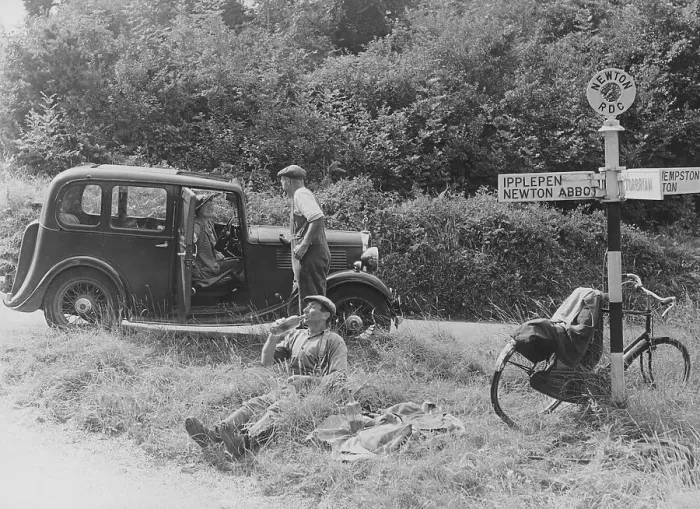 Framed Print : People relaxing by a signpost with a 1935 Standard 10 hp car, Devon, (c1935?) Framed Print : People relaxing by a signpost with a 1935 Standard 10 hp car, Devon, (c1935?)