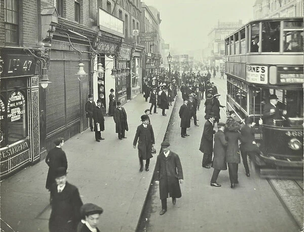People rushing to get on a trolley bus at 7. 05 am, Tooting Broadway, London, April 1912