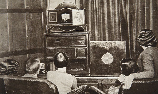 People watching an early television transmission, c1920s