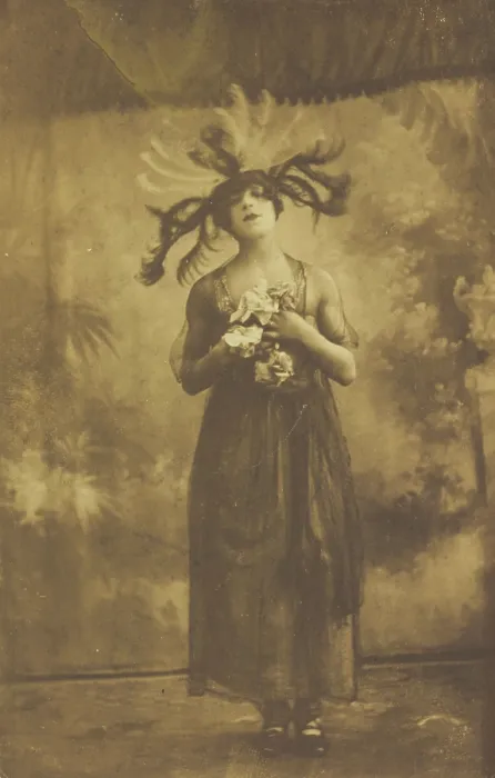 Framed Print : A performer in drag poses on stage wearing a head garment with sprawling feathers, [1910-1919?]. Creator: Unknown