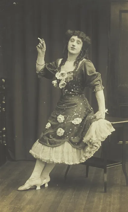 Framed Print : A performer in drag, wearing a large flowery dress, poses with a cigarette on stage, c1908-1910. Creator: Unknown Framed Print : A performer in drag, wearing a large flowery dress, poses with a cigarette on stage, c1908-1910. Creator: Unknown