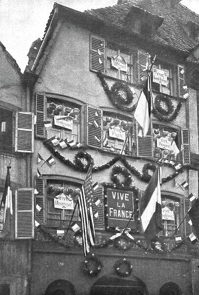 Petain et Foch a Strasbourg; La parure de fete de Strasbourg liberee: deux facades ornees...1918. Creator: Unknown