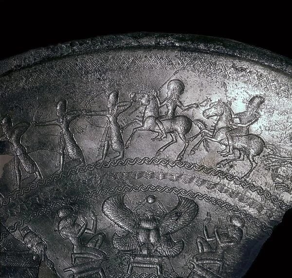 Detail of a Phoenician silver bowl showing soldiers attacking a city, 7th century BC