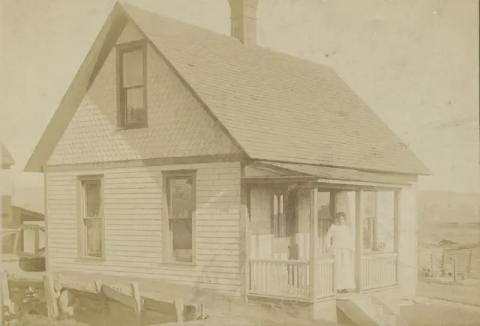Framed Print : Photograph of a woman standing on the porch of a house, early 20th century Framed Print : Photograph of a woman standing on the porch of a house, early 20th century