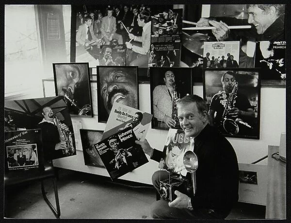 Photographer Denis Williams holding an LP cover