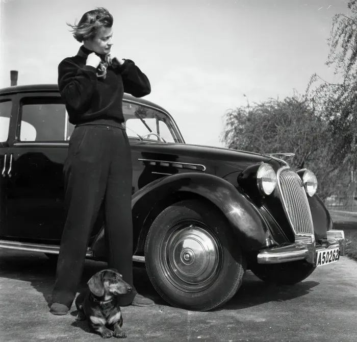 Framed Print : Photographer Kerstin Bernhard stands next to a car with her dachshund, 1955-1960. Creator: Unknown Framed Print : Photographer Kerstin Bernhard stands next to a car with her dachshund, 1955-1960. Creator: Unknown