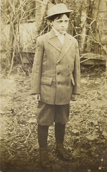 Photographic postcard of a boy wearing a double-breasted jacket and breeches