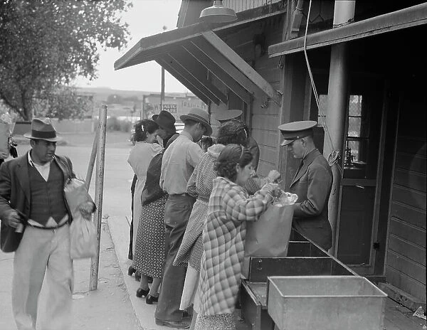 Plant quarantine inspectors examining packages brought over the bridge... Texas, 1937. Creator: Dorothea Lange