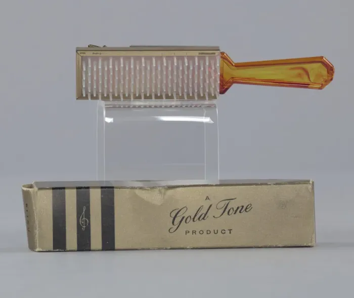 Framed Print : Plastic brush with box from Maes Millinery Shop, 1941-1994. Creator: Gold Tone