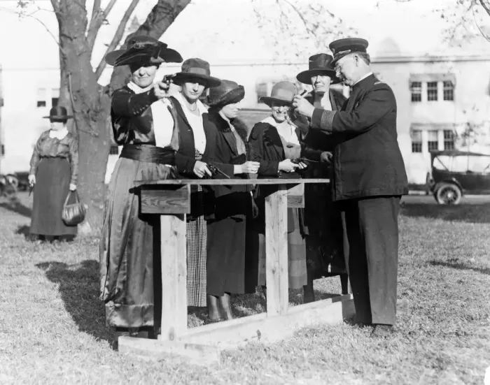 Framed Print : Police officer teaching women how to shoot, c. 1920 Framed Print : Police officer teaching women how to shoot, c. 1920
