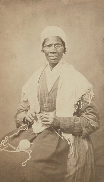 Portrait of abolitionist Sojourner Truth, sitting with yarn and knitting needles, 1864. Creator: JH Preiter