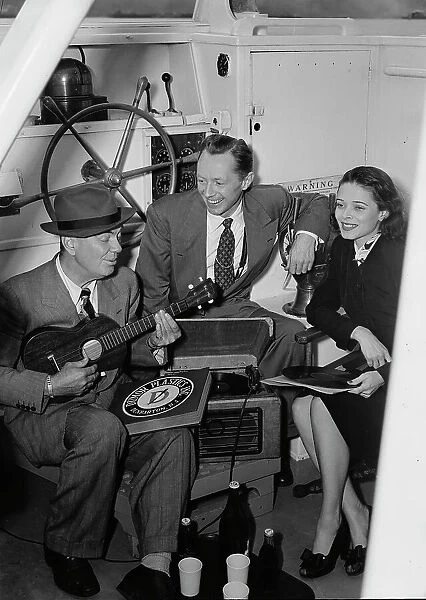 Portrait of Cliff Edwards, Betty Brewer, and Frank... Ukelele Lady (yacht), Hudson River, NY, 1947. Creator: William Paul Gottlieb