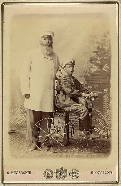 Portrait of an unknown man with a boy sitting on a bicycle, end of 19th century. Creator: PA Milevskii