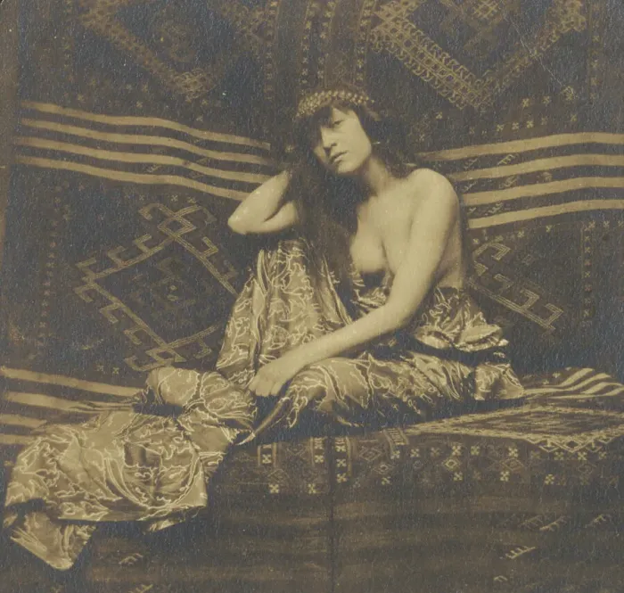 Framed Print : Portrait of a woman, partially draped, seated on a sofa, 1900. Creator: Unknown Framed Print : Portrait of a woman, partially draped, seated on a sofa, 1900. Creator: Unknown