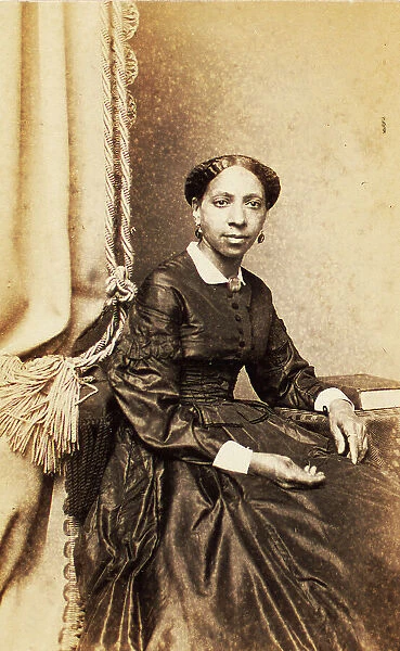 Portrait of woman seated next to tasselled curtain, (1860-1880?). Creator: Abraham Bogardus