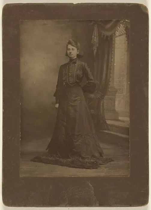 Framed Print : Portrait of a young woman in long black dress, standing, about 1900. Creator: George W Killian Framed Print : Portrait of a young woman in long black dress, standing, about 1900. Creator: George W Killian