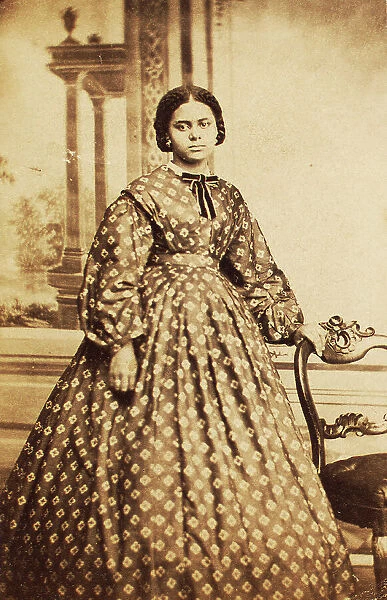 Portrait of young woman wearing patterned dress, with bow at neck, c1860. Creator: Coss & Leach. Portrait of young woman wearing patterned dress, with bow at neck, c1860. Creator: Coss & Leach