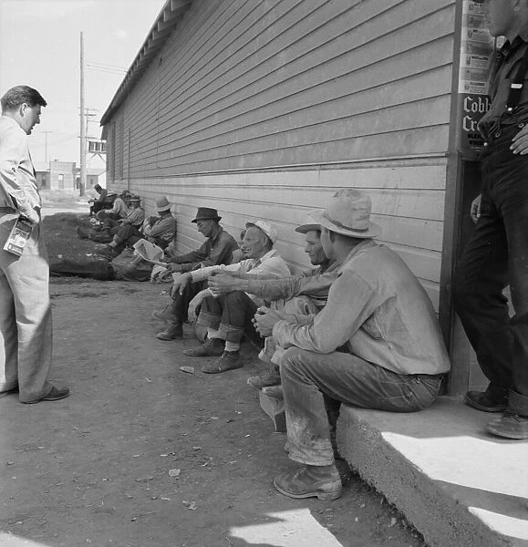 Possibly: Idle men seated in shade on the other side... Tulelake, Siskiyou County, California, 1939 Creator: Dorothea Lange