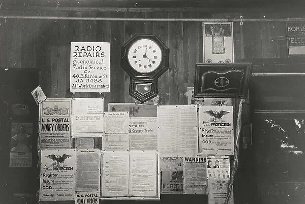 Posters and decorations in combined general store and post office, Olga, Louisiana, 1938-09. Creator: Russell Lee