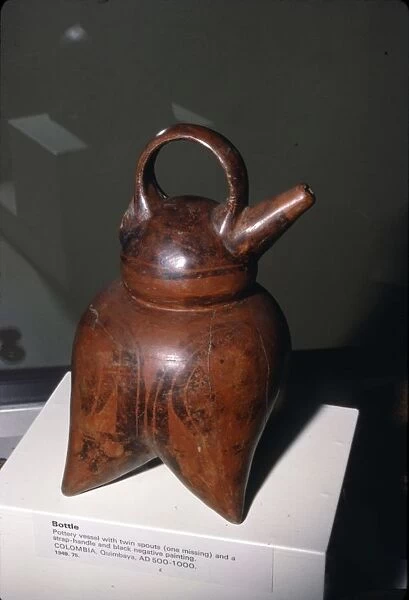 Pottery vessel with twin spouts (one missing) and strap-handle, Quimbaya, Columbia, 500-1000